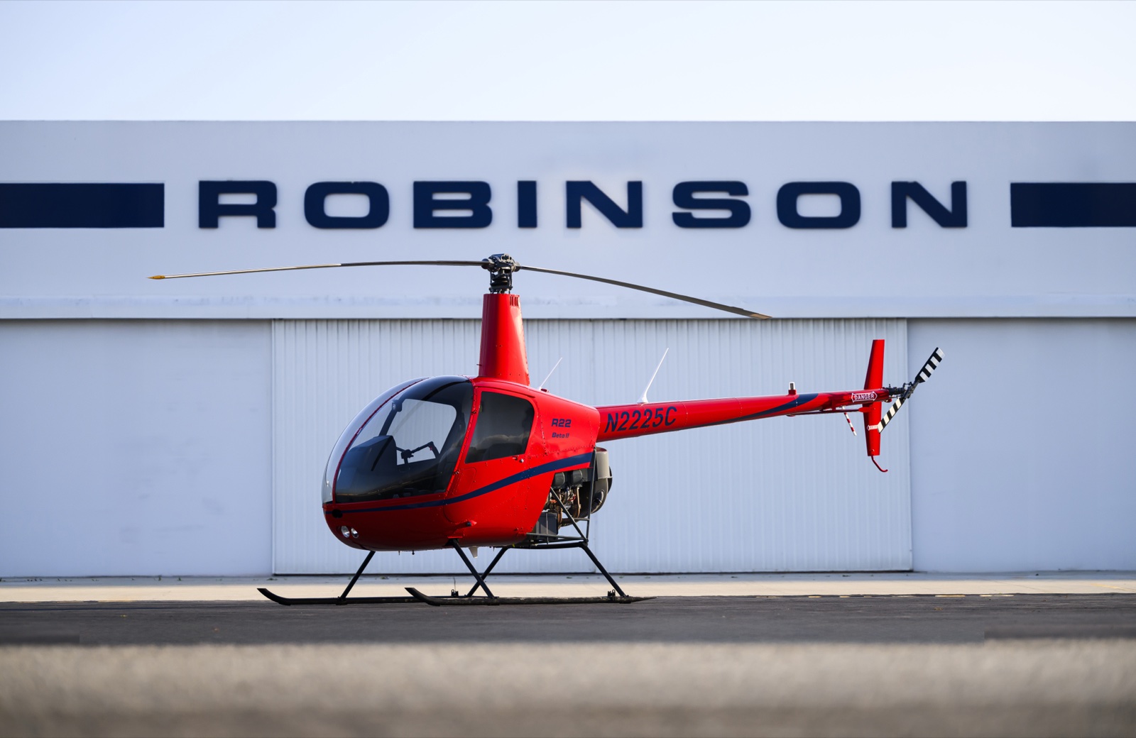 Robinson R22 Beta II parked in front of the Robinson Helicopter Company factory building